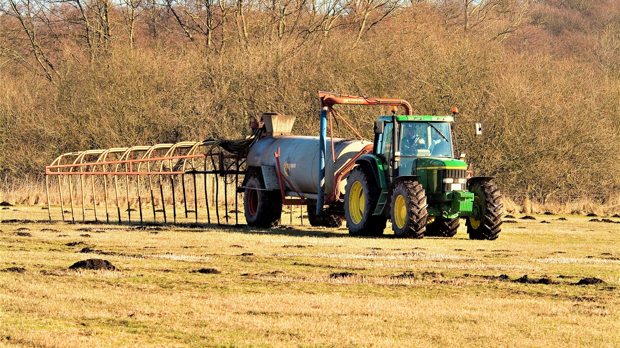En traktor spreder gylle på marken