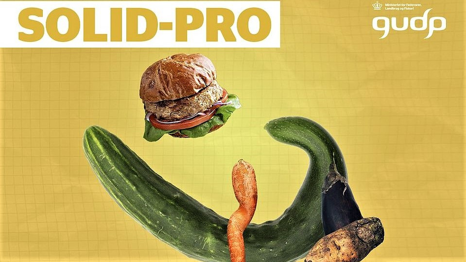Kampagneplakat med deforme grøntsager og en plantebaseret burger