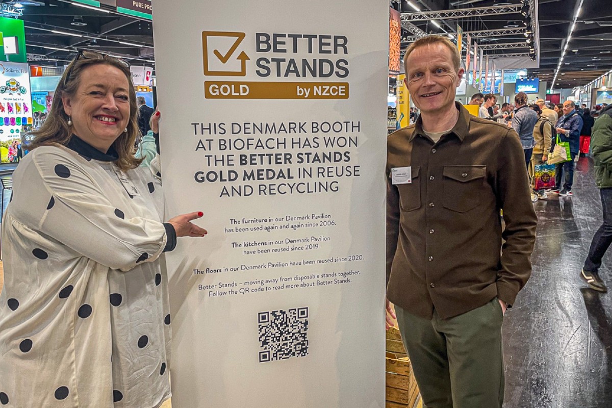 Malene Aaris og Dennis Hvam står ved guldmedaljeplakat fra Better Standsplakat